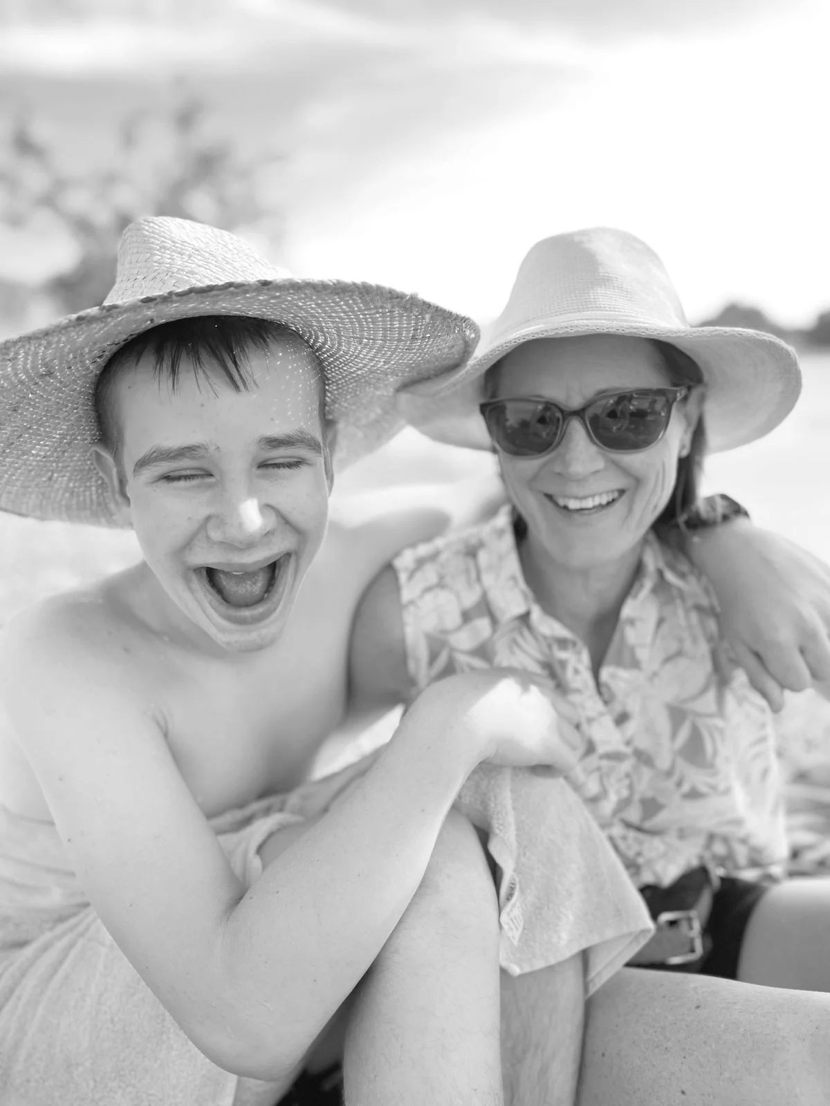 Alison Blair and her son Ewan smiling together, photographed in black and white.